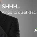 shhh... a nod to quiet discipline. Businessman holding finger to his lips.